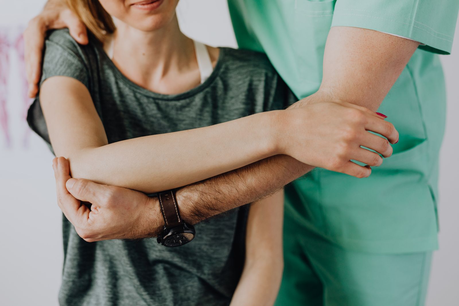 Chiropractic-style manual therapy being applied to a patient's arm and shoulder joint